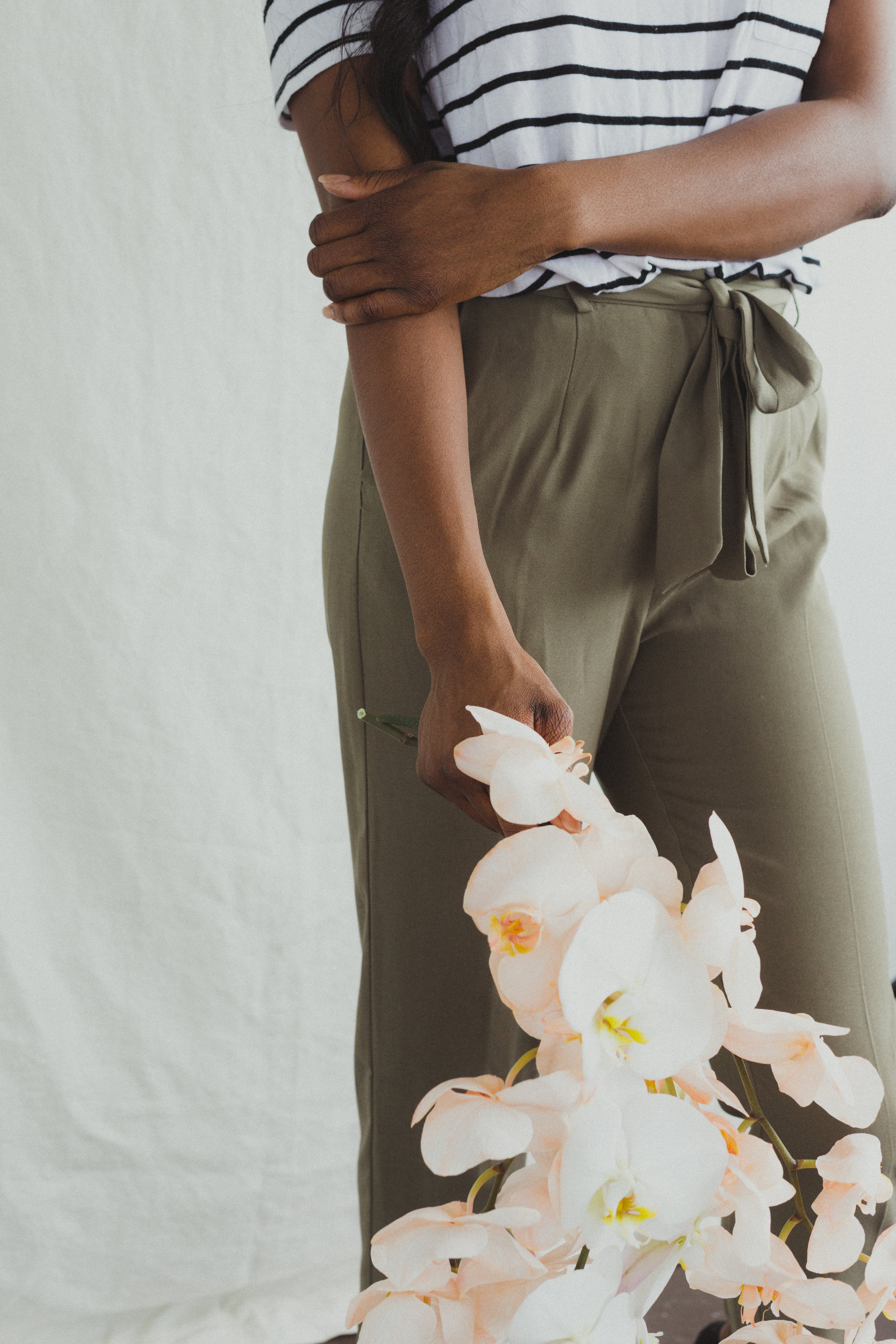 files/a-model-in-khakis-holding-orchids.jpg